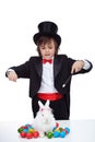 Magician boy perform a magic trick with the easter bunny and some colorful eggs Royalty Free Stock Photo