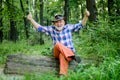 Magician in forest. Woodman magician concept. Folk magic. Mature man with beard in hat. Wise old man. Herbal remedies