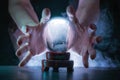 Magician or fortune teller is predicting future with crystal sphere. Royalty Free Stock Photo