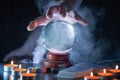 Magician or fortune teller is predicting future with crystal sphere. Royalty Free Stock Photo
