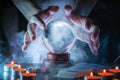 Magician or fortune teller is predicting future with crystal sphere.