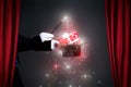 Magician hand with magic wand making Christmas gift Royalty Free Stock Photo