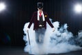 Magician, Juggler man, Funny person, Black magic, Illusion standing on the stage with a cane of beautiful light Royalty Free Stock Photo
