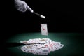 Magician performing trick playing cards with magic wand poker table . High quality and resolution beautiful photo concept Royalty Free Stock Photo