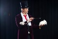 Magician with rabbit, Juggler man, Funny person, Black magic, Illusion on a black background Royalty Free Stock Photo