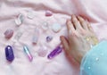 magician's hand holds, selects the necessary crystals and minerals for a session of harmonization, crystal therapy, healing Royalty Free Stock Photo