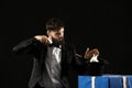 Magician showing tricks with rabbit on dark background Royalty Free Stock Photo