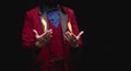 Magician shows trick with fire burn from palms hands