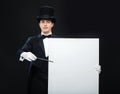 Magician in top hat with magic wand showing trick Royalty Free Stock Photo