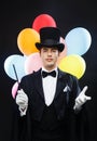 Magician in top hat with magic wand showing trick Royalty Free Stock Photo