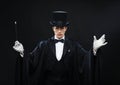 Magician in top hat with magic wand showing trick Royalty Free Stock Photo