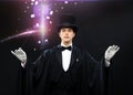 Magician in top hat with magic wand showing trick Royalty Free Stock Photo
