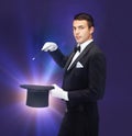 Magician in top hat with magic wand showing trick Royalty Free Stock Photo