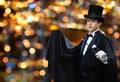 Magician in top hat showing trick with magic wand Royalty Free Stock Photo