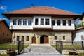 Facade of an old renovated house from the Ottoman times against a blue cloudy sky in Maglaj