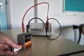 Magnet is pushed into a copper coil, inducing an electrical current through induction