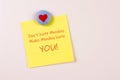 Magnet and yellow sticky note reminder to not hate Monday on refrigerator Royalty Free Stock Photo