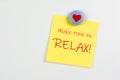 Magnet and yellow sticky note reminder to relax on refrigerator Royalty Free Stock Photo