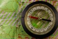 Magnetic compass is located on a topographic map Royalty Free Stock Photo