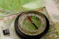 Magnetic compass is located on a topographic map Royalty Free Stock Photo