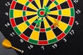 Magnetic dart arrows on dartboard. Black background Royalty Free Stock Photo