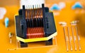 Magnetic ferrite core transformer detail on beige printed circuit board