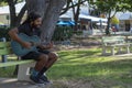 Magnetic Island, Australia - December 2019: Hippie Aboriginal Playing Guitar