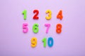 Magnetic multi-coloured numbers on purple background with copy space. Back to school Royalty Free Stock Photo