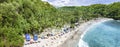 Magnificent aerial side view panorama photo of tropical beach at the end of mountain valley with coconut palms, boats in blue Royalty Free Stock Photo