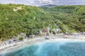 Magnificent aerial view of tropical beach at end of mountain valley with coconut palms, boats in blue water in Ocean gulf, Royalty Free Stock Photo