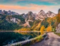 Magnificent autumn view of Gosausee Vorderer lake with asphalt walkway road. Spectacular morning scene of Austrian Alps, Upper A