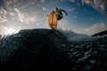 magnificent bottom view of male wakeboarder while jumping over splashing wave