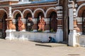 Russia, Yaroslavl, July 2020. A beggar at the brick fence of the Orthodox Church.