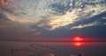 Magnificent dreamy sunset over the water surface of lake on background of setting sun and colorful clouds Royalty Free Stock Photo