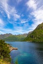 Magnificent fjord in lofoten islands in norway with blue water and cloudy sky over high mountains Royalty Free Stock Photo