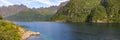 Magnificent fjord in lofoten islands in norway with blue water and cloudy sky over high mountains Royalty Free Stock Photo