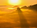 Magnificent fogy landscape , spring misty sunrise in a beautiful valley. Hills increased from fog, the fog is colored to gold
