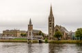 Bridge over river Ness leading to the famous tall Gothic style Free Church of Scotland, Inverness Royalty Free Stock Photo