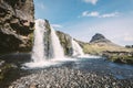 Magnificent Kirkjufellsfoss waterfall with white spray in Iceland.