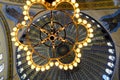 Magnificent lightning chandelier with candles and interior dome background and details of Hagia sophia.