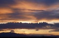 Magnificent mountain sunset with golden highlight against grey clouds Royalty Free Stock Photo