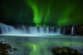 A magnificent night view of the cascades of the waterfall and the northern lights. Royalty Free Stock Photo