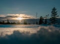Magnificent photo of vertical light orange Sun beam shining from behind of heavy clouds down to pine tree forest. Winter snowy Royalty Free Stock Photo