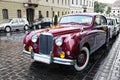 The magnificent retrocar the Jaguar to stand on the ancient street of Budapest Royalty Free Stock Photo