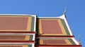 Magnificent roof in a Thai temple. The intricate details of traditional Thai temple roofs contrast with blue sky. Royalty Free Stock Photo