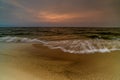 Magnificent seascape at sunset with stones covered seaweeds Royalty Free Stock Photo