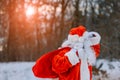 Magnificent snow covered landscape Santa Claus carrying Merry Christmas present gifts