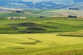 Magnificent spring rural landscape. Stunning view of tuscan green wave hills, amazing sunlight, beautiful golden fields and meadow Royalty Free Stock Photo