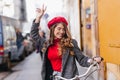 Magnificent stylish girl in red sweater expressing true emotions sitting on bicycle. Outdoor photo of brunette lady in Royalty Free Stock Photo