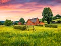 Magnificent summer sunrise on Yasinya village with wooden houses, Ukraine, Europe.